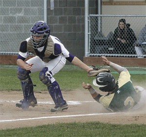 Oak Harbor catcher Mike Maletto reaches to tag a Marysville Getchell base runner Tuesday.