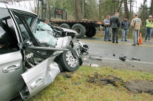 Washington State Patrol Trooper Josh Lancaster speaks with people who heard the impact of a minivan that collided with a semi-truck on Taylor Road Monday morning. The crash sent the 77-year-old Oak Harbor driver to Island Hospital in Anacortes.