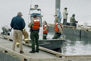 Deception Pass Park staff and North Whidbey Fire and Rescue firefighters await the county coroner to claim the body of a woman who jumped from the Deception Pass Bridge Tuesday afternoon.