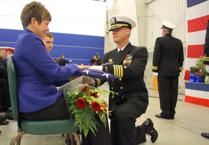 Retiring base commander Capt. Mike Nortier delivers the flag to his wife while his children look on. Nortier said he plans to stay in Oak Harbor after retiring.