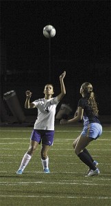 Faith Franssen prepares to head a ball in Oak Harbor's match with Everett Thursday.