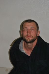 A deputy photographs Joshua Lambert soon after he was arrested for a double murder.