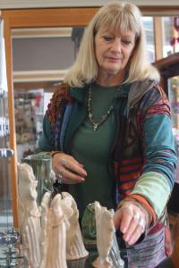 Lyla Lillis adjusts the display of her abstract angels at Garry Oak Gallery. Lillis is one of the two featured artists of October.