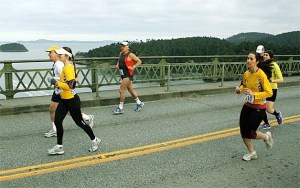 Runners last year cross the Deception Pass bridge near the start of the Whidbey Island Marathon. The bridge will be closed from 7:15 a.m.-7:45 a.m. Sunday.