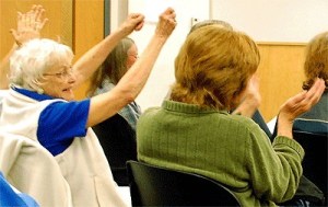 Helen Chatfield-Weeks holds up a sign during an Island County commissioners’ meeting Monday where the commissioners approved a resolution urging a constitutional amendment to reverse the Citizens United decision.