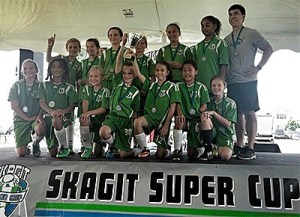 The Islanders show off their trophy after winning the Skagit Cup last summer.