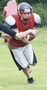 Cole Payne works on receiving handoffs in Coupeville's spring football camp.