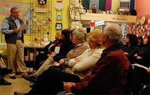 Oak Harbor Mayor Jim Slowik speaks to a tough crowd at Paint Your World downtown. Slowik and the City Council attended the Harborside Merchants Association meeting Tuesday to gather ideas about city-funded marketing during the construction phase of the SE Pioneer Way Improvement Project.