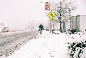 Michelle Rouse walks on Pioneer Way toward a bus stop during a Wednesday morning snow storm.