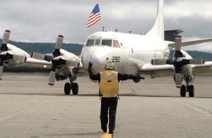 A P-3 Orion is guided on the tarmac at Whidbey Island Naval Air Station. Admiral Gary Roughead