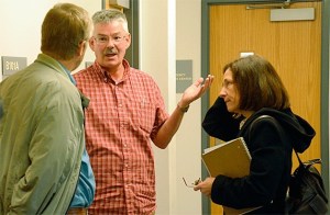 Norcliffe resident Jack Lyons speaks with former Island County commissioner Angie Homola following a decision by the current board of commissioners Wednesday not to move forward with no shooting rules.
