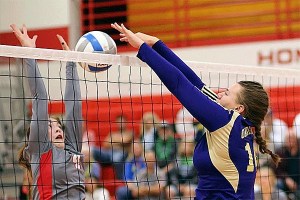 Oak Harbor's Julie Jansen tips in front of Stanwood's Emma Bash Tuesday.