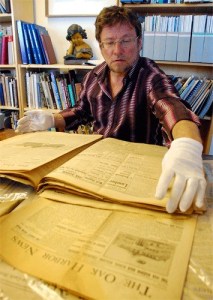 Martin Elliot of the Island County Historical Society’s Oak Harbor chapter pores through old newspapers searching for history about the city’s downtown area.