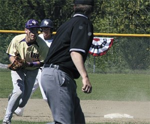 Oak Harbor shortstop Brent Mertins scoops up a slow roller and gets ready to fire to first.