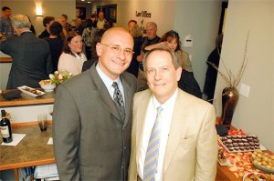 Douglas Saar and Christon Skinner of the Law Offices of Skinner and Saar pause for a photo during a ribbon cutting ceremony at their new location on Barrington Drive.