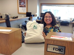 Patty Briseno holds up the disaster kit for pets she won in a Whidbey Island Bank raffle.
