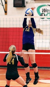 Claire Anderson blocks a Lynnwood hit in Tuesday's win. Anderson led Oak Harbor with 21 kills and 15 digs.
