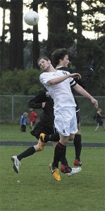 Coupeville's Luke Pelant heads the ball for Coupeville against Archbishop Murphy.