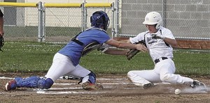 Oak Harbor's Kevyn Johnson slides around South Whidbey catcher Cole Payne as the ball gets away.