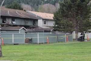 Fences are erected around an apartment building damaged by fire.