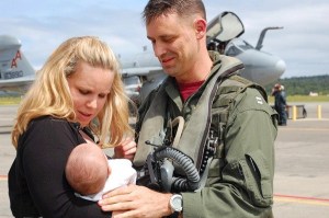 Janice Fatora presents seven-week-old Brendan to his father