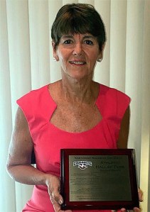 Darlene Brasch holds her Northwest Nazarene University Athletic Hall of Fame plaque she received Nov. 13.
