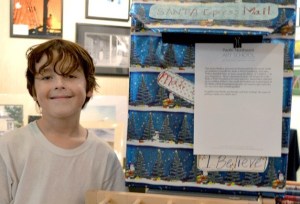Jonathan Carroll stands next to the mailbox he designed to collect letters for Santa Claus.