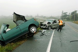 A trooper from the Washington State Patrol scans over the wreckage of a collision that killed an Anacortes woman Friday morning.