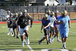 Oak Harbor football players run through some warm up drills at practice Friday.
