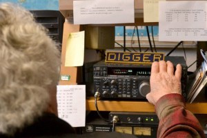 Digger O’Dell operates radio equipment at the MARS station aboard NAS Whidbey Island. MARS operators will send children’s Christmas wish lists to Santa through the radio system.