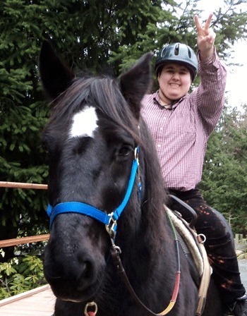 Equestrian Crossings student Doma Brown loves riding the big Percheron Kirbey.