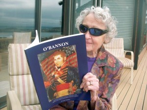 Relaxing on her front porch as the sun rises over Oak Harbor Bay