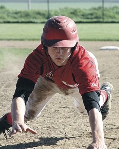 Josh Bayne dives back to first on a pick off attempt Wednesday.
