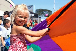 A young festival-goer takes part in a parachute game for children during Sunday’s Oak Harbor Pigfest. The seventh annual event