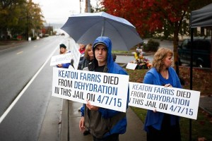 Fred Farris stands outside of Island County Jail Wednesday with other friends and family to mark the six-month anniversary of his son’s death from dehydration at the jail.