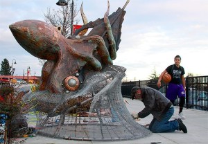 A passerby gets a look Wednesday at the new kraken sculpture created by Oregon artist Bill Hunt