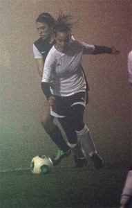 Coupeville's Ana Luvera chases down the ball against Archbishop Murphy as a deep fog muffles Mickey Clark Field.