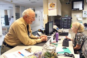 Whidbey General Hospital chaplain Dave Engle chats with Kathryn Clay