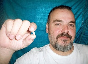 Mark Spadaro displays the hunk of plastic found in his daughter’s chicken fajita pita purchased at the Oak Harbor Jack-in-the-Box. The local store offered to refund only the price of the fajita