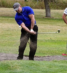 Navy's Ron Coleman blasts out of the sand in Friday's round of the Rainier Cup at the Gallery Friday.