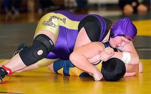 Oak Harbor's Amber Cramsey-Behnke prepares to turn Burlington-Edison's Elizabeth Ramirez on the way to a pin. Cramsey-Behnke finished third in the subregional tournament.