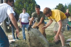 Jordan Lamb and Nathan Saunders muscle aside a rock.