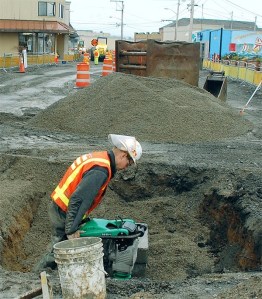 Strider Construction pipe layer Ben Harem works in a hole on SE Pioneer Way. This week marked the end of the first month of construction.