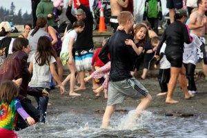 Participants make a quick exit from the chilly lagoon in Windjammer Park after the first polar bear plunge in Oak Harbor Jan. 1
