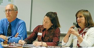Island County commissioners John Dean and Angie Homola listen as Commissioner Helen Price Johnson responds to a question from the crowd during the July 13 forum in Oak Harbor concerning Proposition 1.