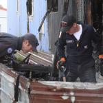 Charlie Smith, left, and Jerry Helm, with Central Whidbey Fire & Rescue, and Mike Buxton of the Oak Harbor Fire Department, investigate a fire at Terry Mobile Park in Coupeville Thursday, Sept. 29, 2916&mdash; Image Credit: Ron Newberry