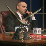 President Charles Smith rolls his eyes as he argues with one of his colleagues on the phone.