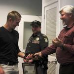 Photo by Kyle Jensen / Whidbey News-Times                                Tony Hartman, right, gives Eric Vasilyev, left, the belt that was used as a makeshift tourniquet to slow blood flow to his injured arm.