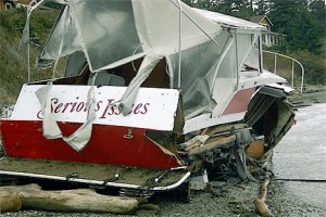 A small boat dubbed “Serious Issues” breaks up near the driftwood on the north edge of Penn Cove Monday.