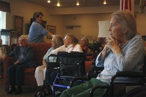 Jean Marchese and other residents of HomePlace gather to listen to uplifting songs for their first afternoon activity Thursday. Danell Broyles said that as long as the singing won’t overstimulate the resident